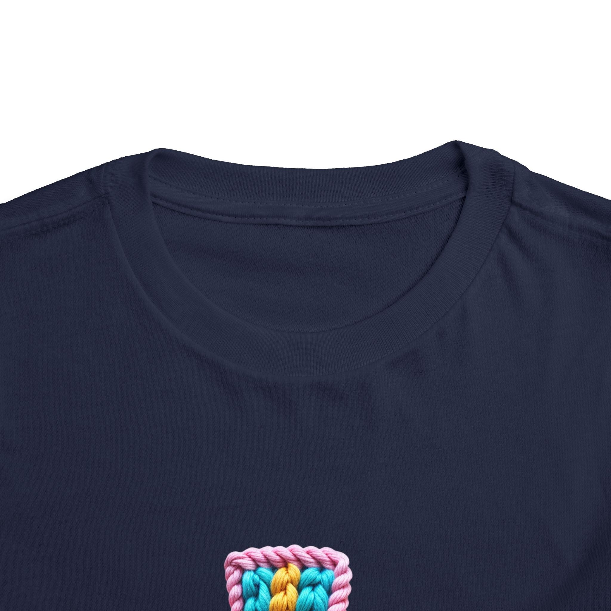 Easter Cross Toddler Tee — Colorful Knit Cross with "He is Risen" & Easter Eggs