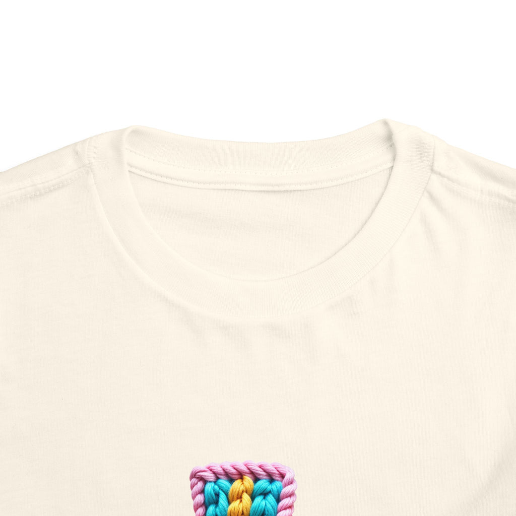 Easter Cross Toddler Tee — Colorful Knit Cross with "He is Risen" & Easter Eggs