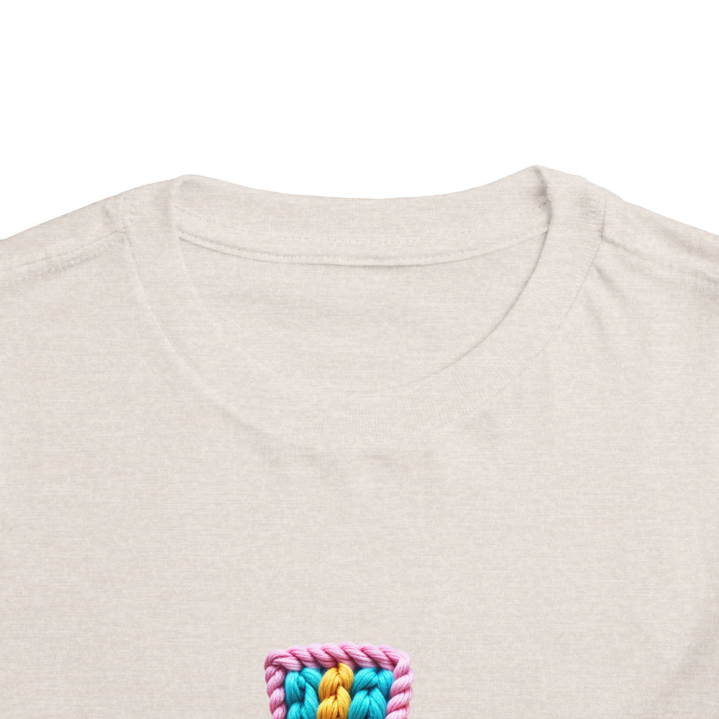 Easter Cross Toddler Tee — Colorful Knit Cross with "He is Risen" & Easter Eggs