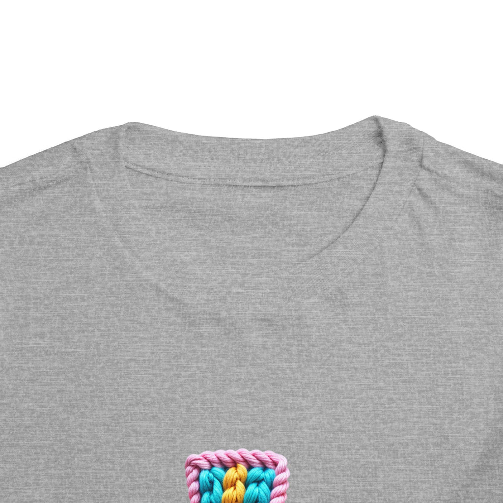 Easter Cross Toddler Tee — Colorful Knit Cross with "He is Risen" & Easter Eggs