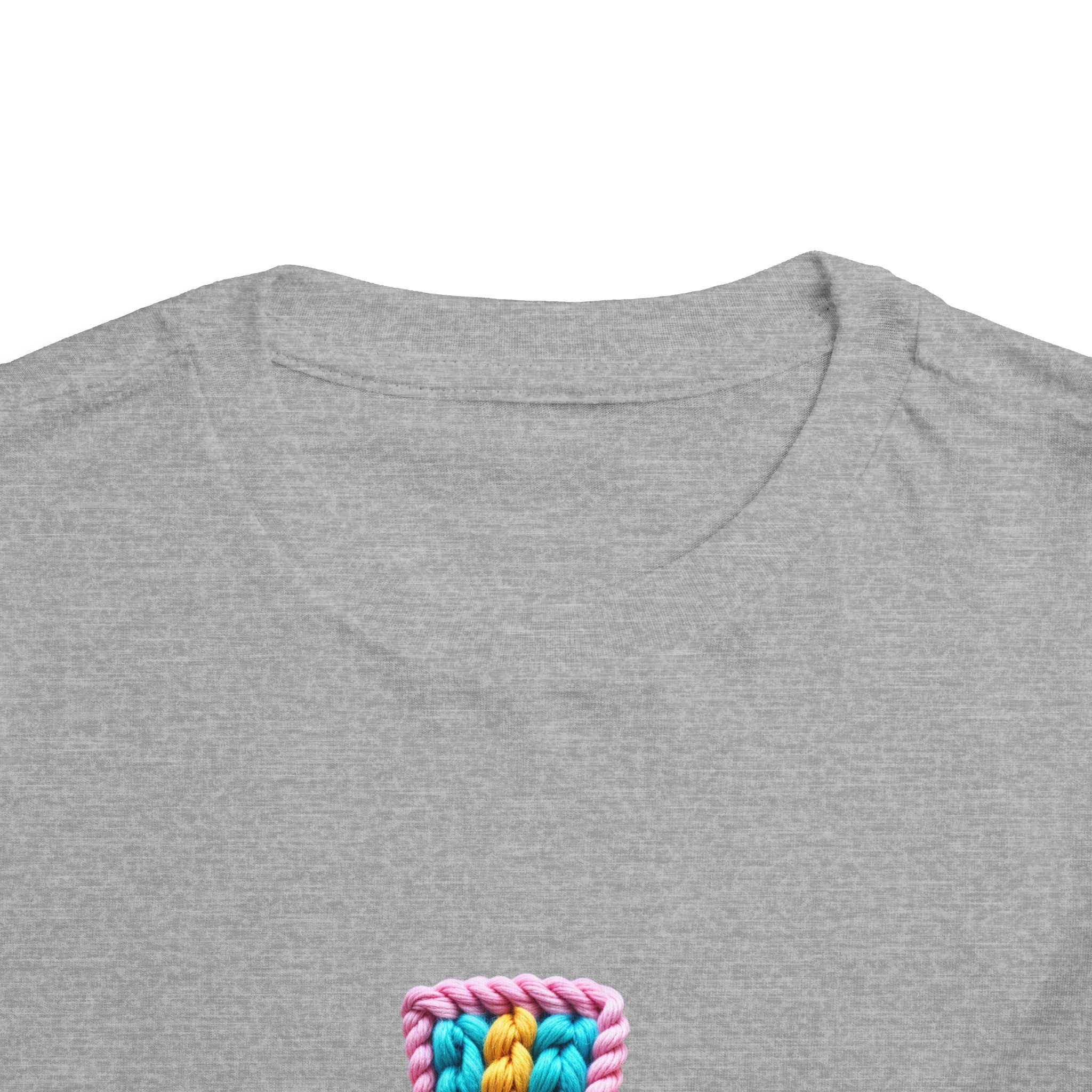 Easter Cross Toddler Tee — Colorful Knit Cross with "He is Risen" & Easter Eggs