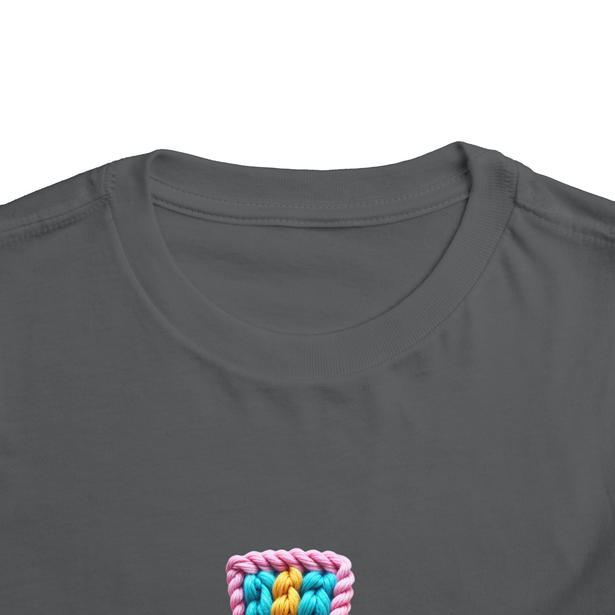 Easter Cross Toddler Tee — Colorful Knit Cross with "He is Risen" & Easter Eggs