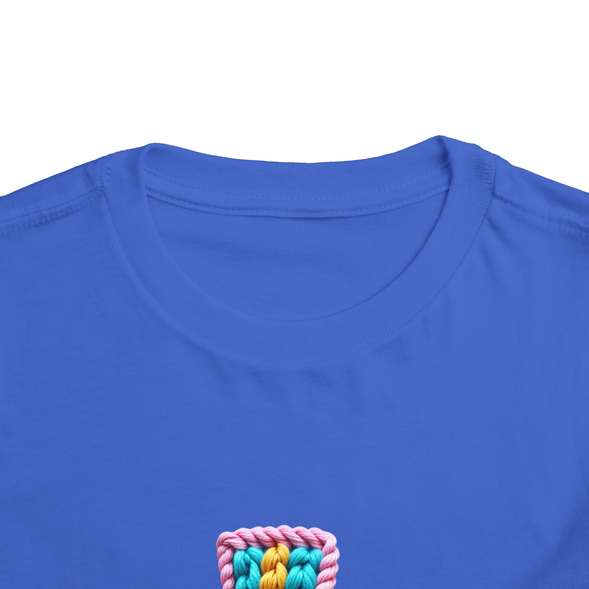 Easter Cross Toddler Tee — Colorful Knit Cross with "He is Risen" & Easter Eggs