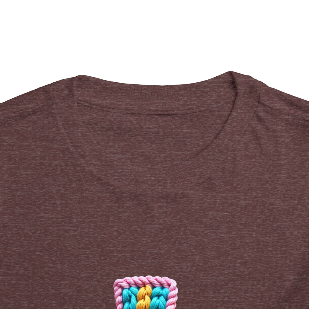 Easter Cross Toddler Tee — Colorful Knit Cross with "He is Risen" & Easter Eggs