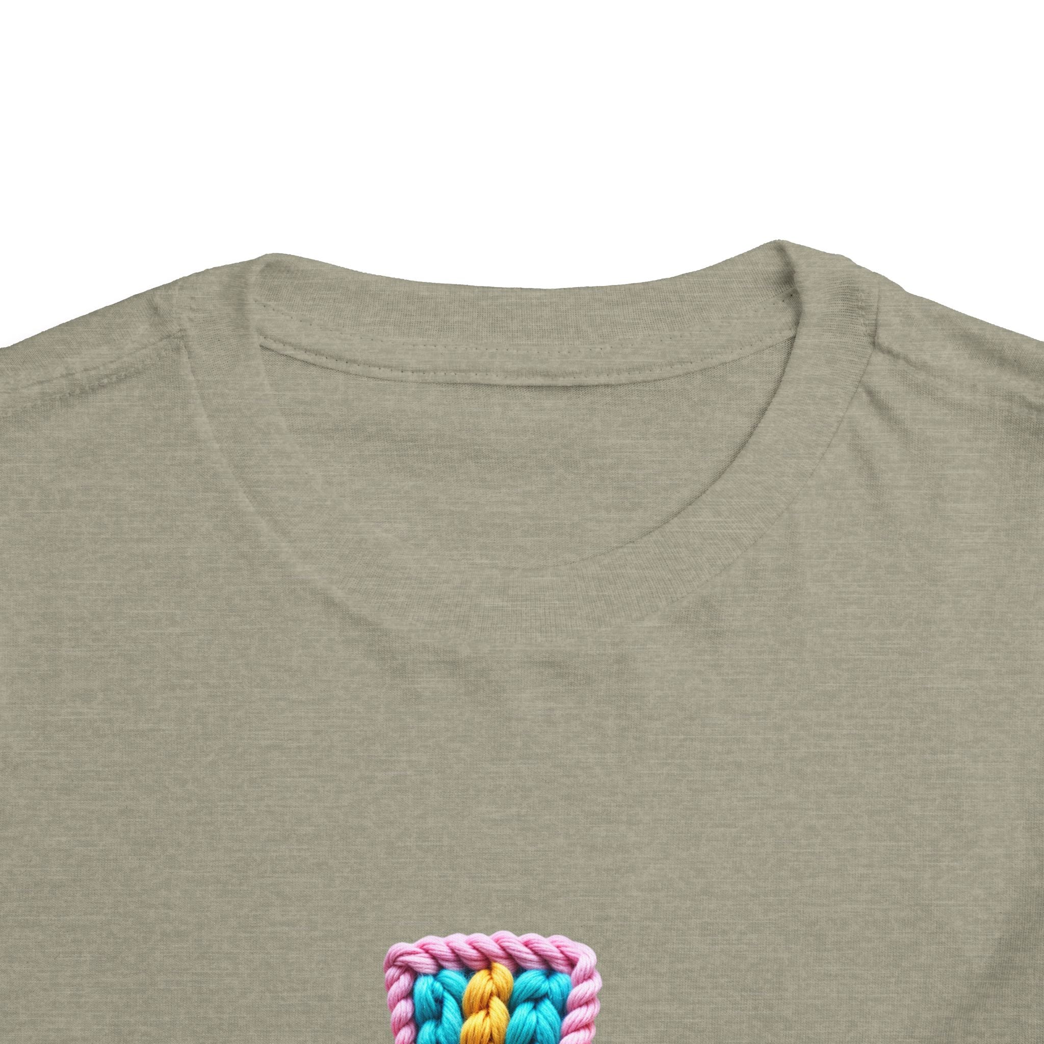Easter Cross Toddler Tee — Colorful Knit Cross with "He is Risen" & Easter Eggs