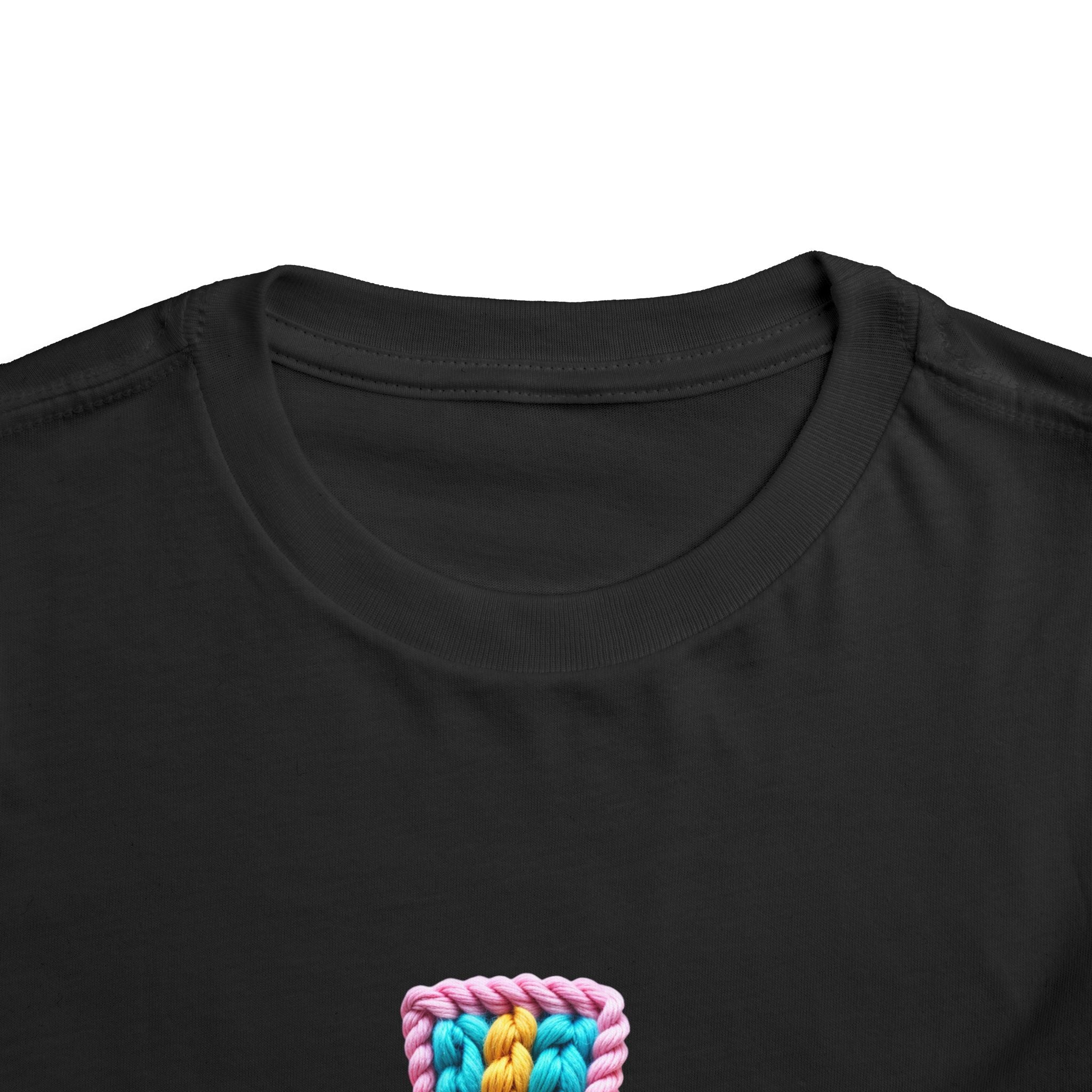 Easter Cross Toddler Tee — Colorful Knit Cross with "He is Risen" & Easter Eggs