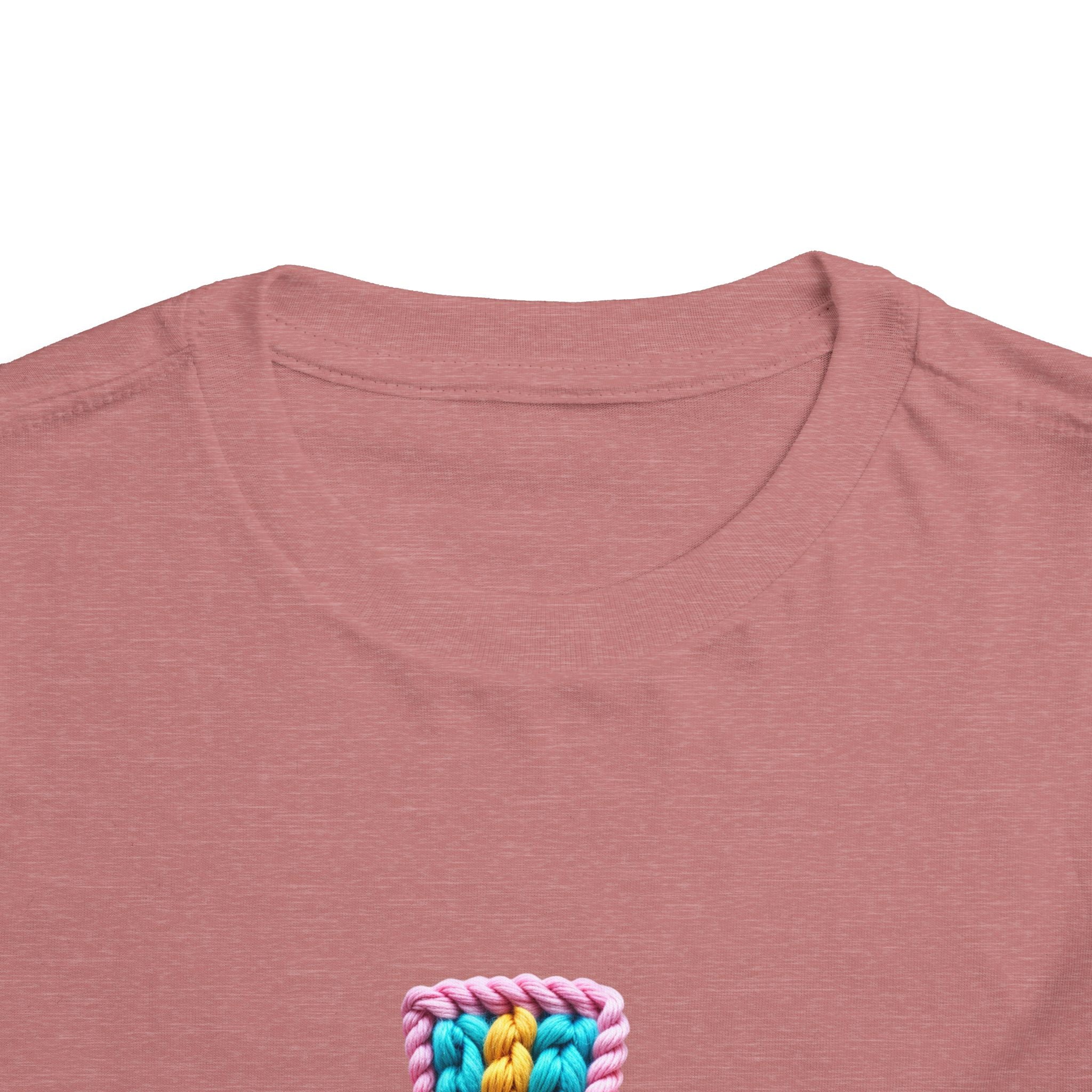 Easter Cross Toddler Tee — Colorful Knit Cross with "He is Risen" & Easter Eggs